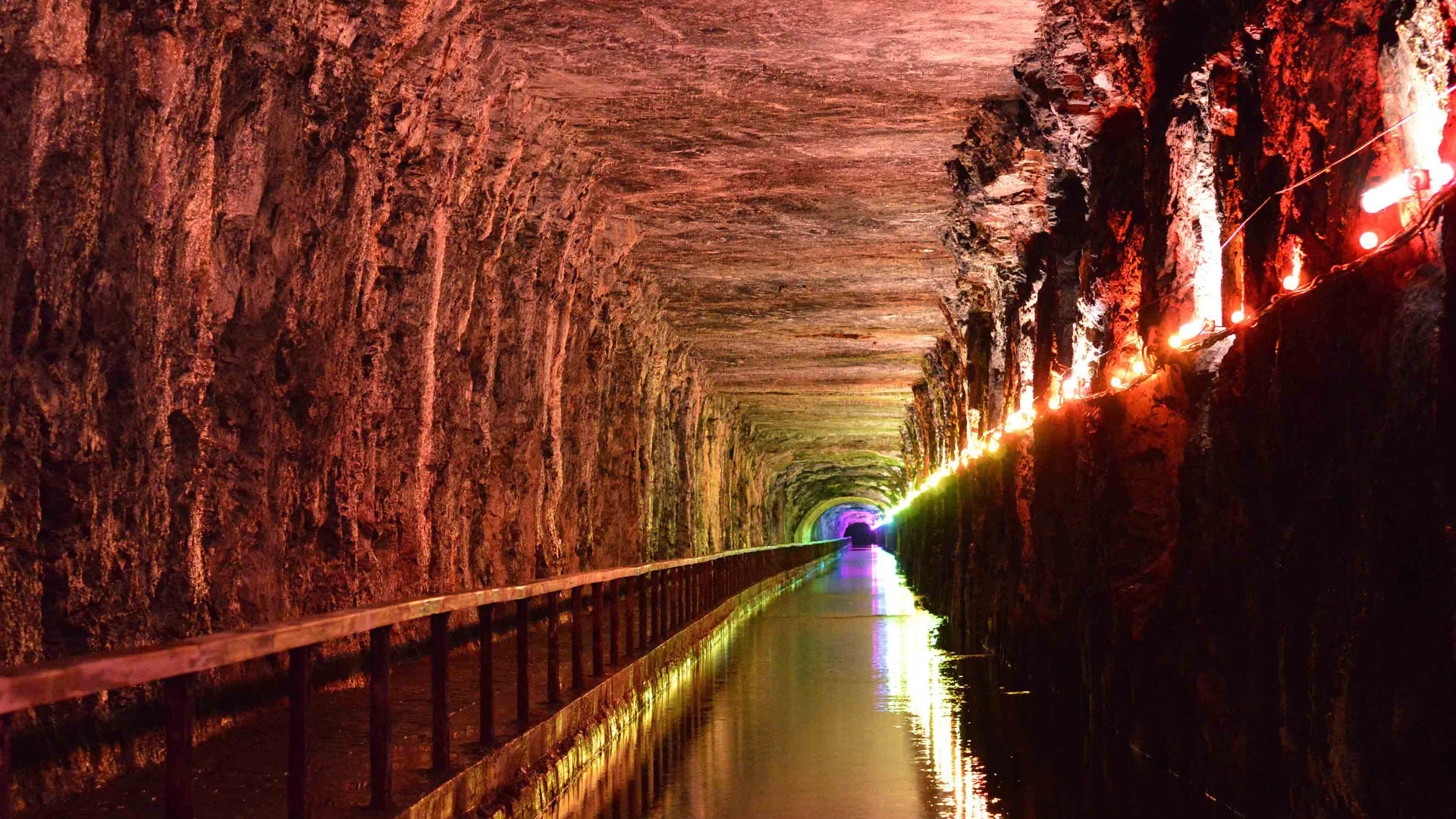 Warm red colour scene along the rock-cut tunnel and canal