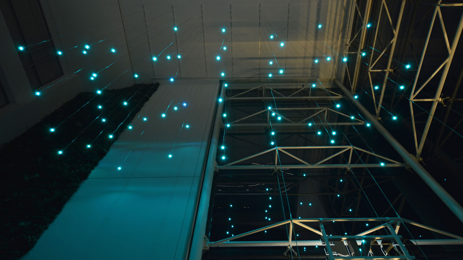 Atrium ceiling in teal — bespoke RGBW Globe pendants on crystal cable
