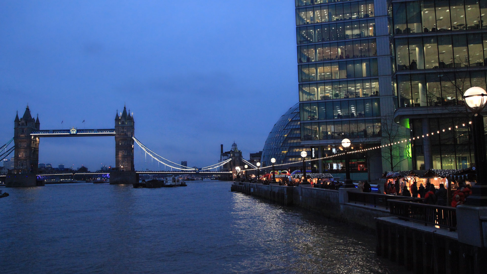 The Thames at blue hour — riverside walkway beside Tower Bridge